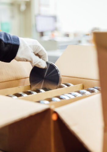 A new dental disk is removed from a box.