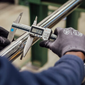 Employees testing titanium rods (quality assurance)